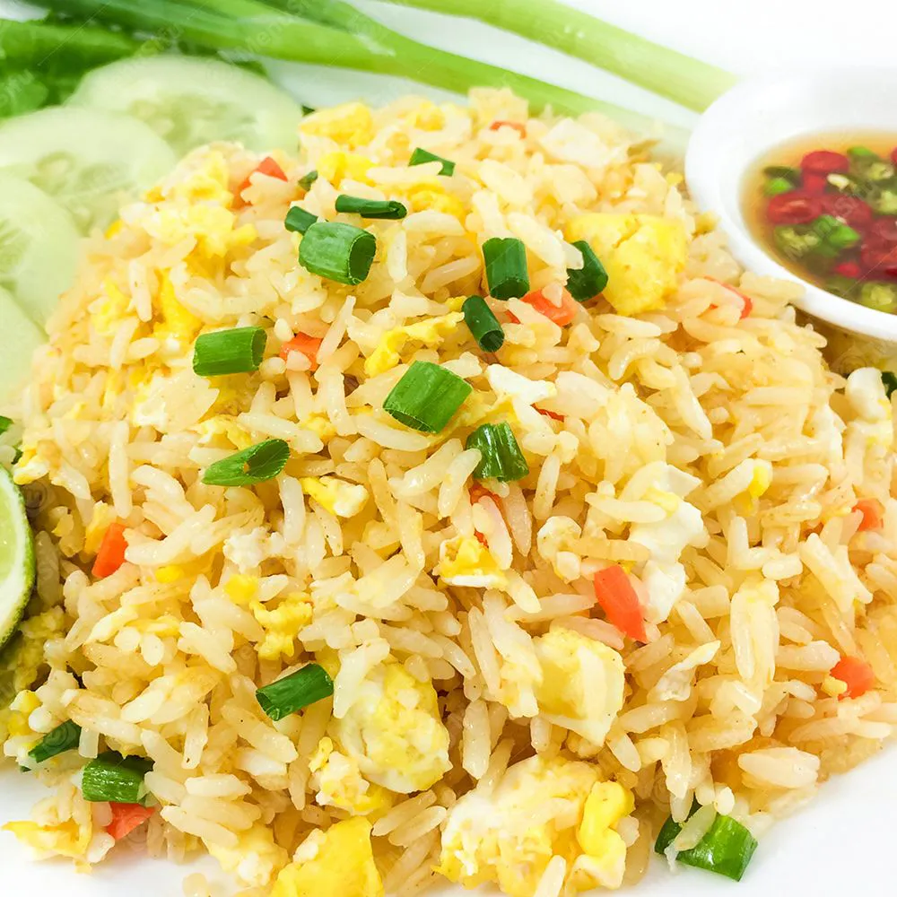 Classic egg fried rice served with cucumber, lime and chili fish sauce at Chinese Wok, a Chinese Restaurant in Seymour